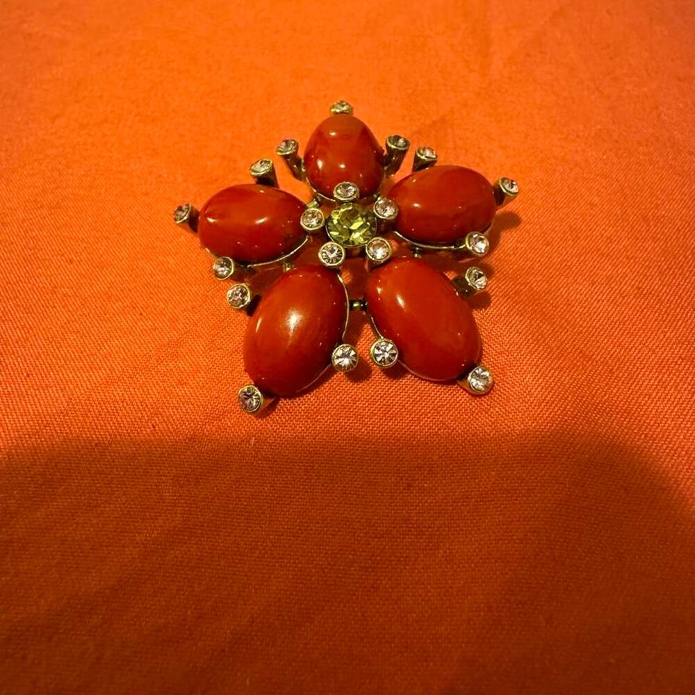 Red plastic beaded brooch with rhinestones and gold toned base
